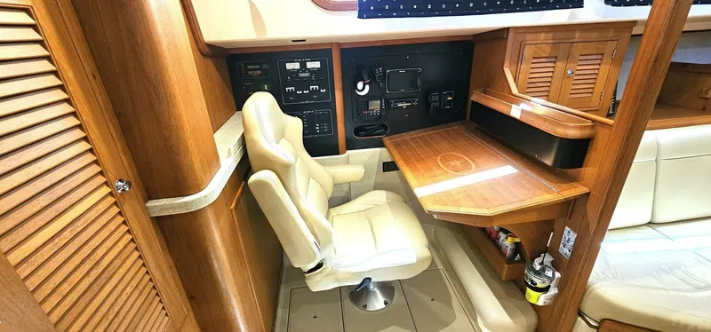 Slide: The Image of Navigation station in 2009 Island Packet 465 yacht with wooden desk and beige chair. - 5