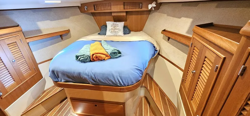 Slide: The Image of Luxurious cabin interior of 2009 Island Packet 465 yacht with cozy bed and wooden finishes. - 9