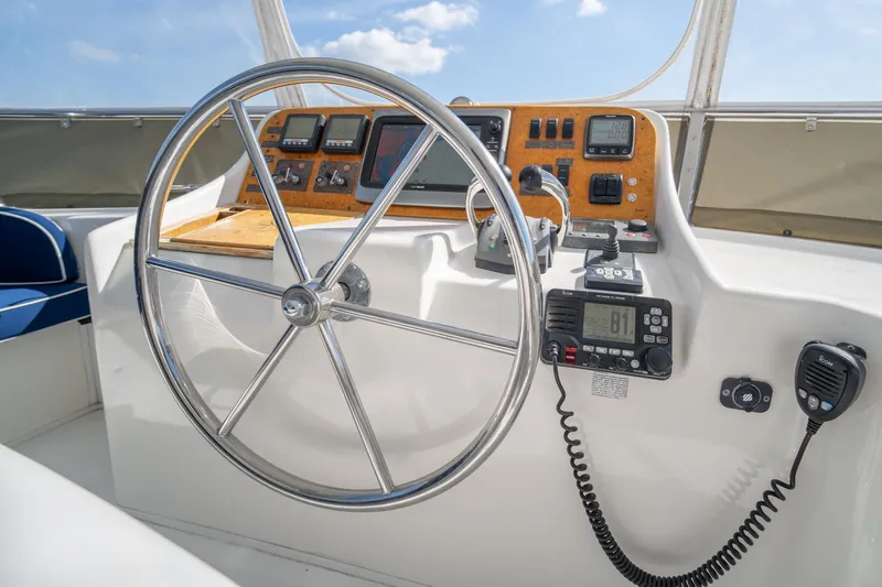 Slide: The Image of 2007 Ocean Alexander 52 Sedan helm with steering wheel and navigation instruments. - 16