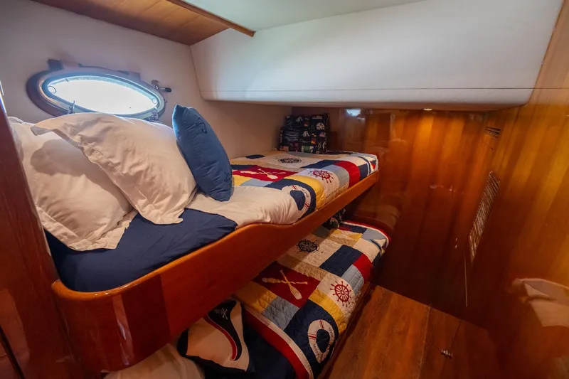 Slide: The Image of Interior of 2007 Ocean Alexander 52 Sedan with cozy bunk beds and nautical-themed decor. - 24