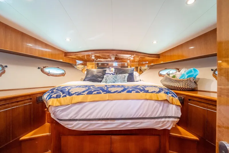 Slide: The Image of Luxurious 2007 Ocean Alexander 52 Sedan yacht bedroom with elegant wood finish and plush bedding. - 29