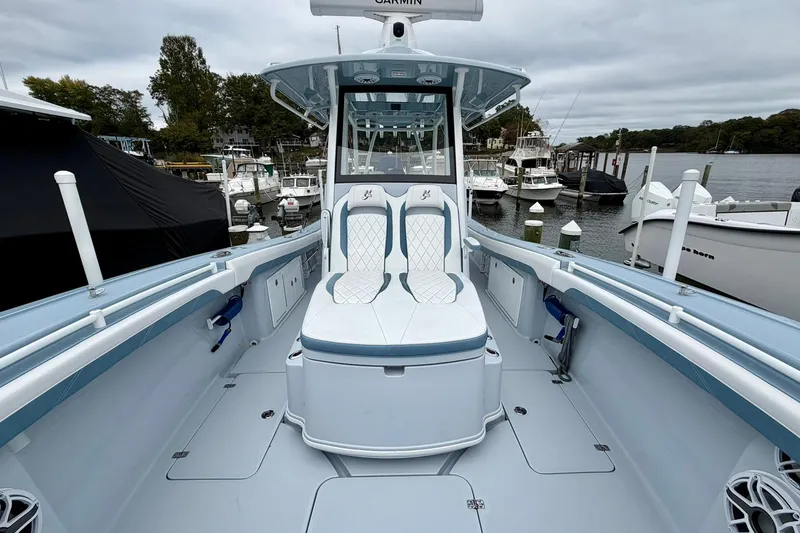 Slide: The Image of 2025 Yellowfin 36 Offshore boat with sleek seating, docked at a marina. - 10