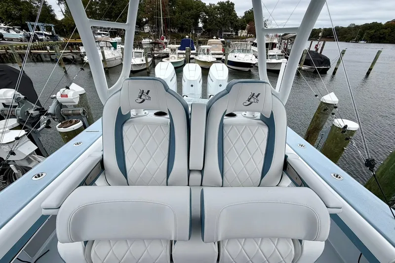 Slide: The Image of 2025 Yellowfin 36 Offshore boat with luxurious seating at a marina. - 12