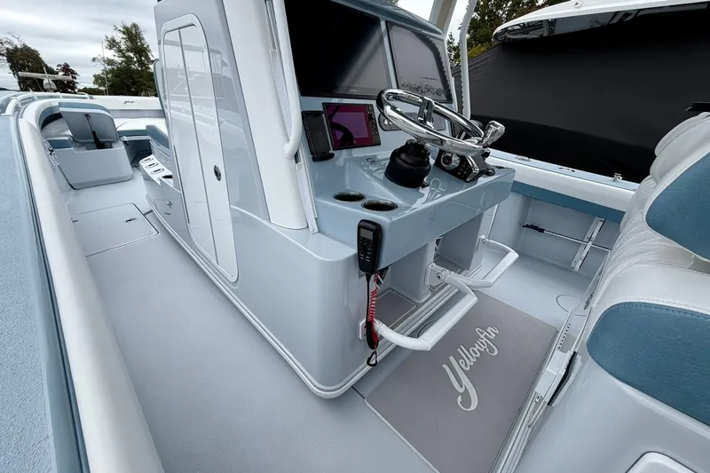 Slide: The Image of 2025 Yellowfin 36 Offshore boat interior with modern helm and seating. - 19