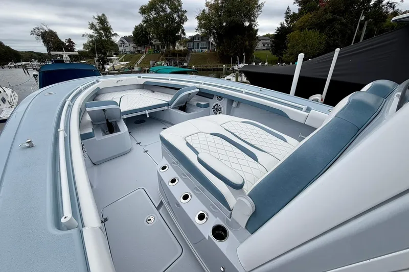 Slide: The Image of 2025 Yellowfin 36 Offshore boat interior with cushioned seating and rod holders. - 20