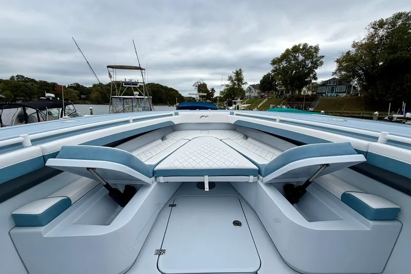 Slide: The Image of 2025 Yellowfin 36 Offshore boat interior with cushioned seating and storage compartments. - 21