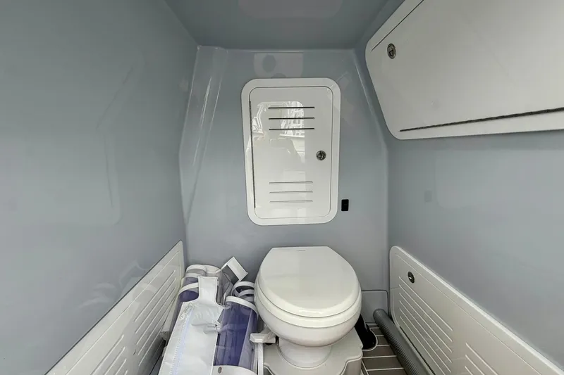 Slide: The Image of 2025 Yellowfin 36 Offshore boat interior with modern marine toilet and storage compartments. - 25