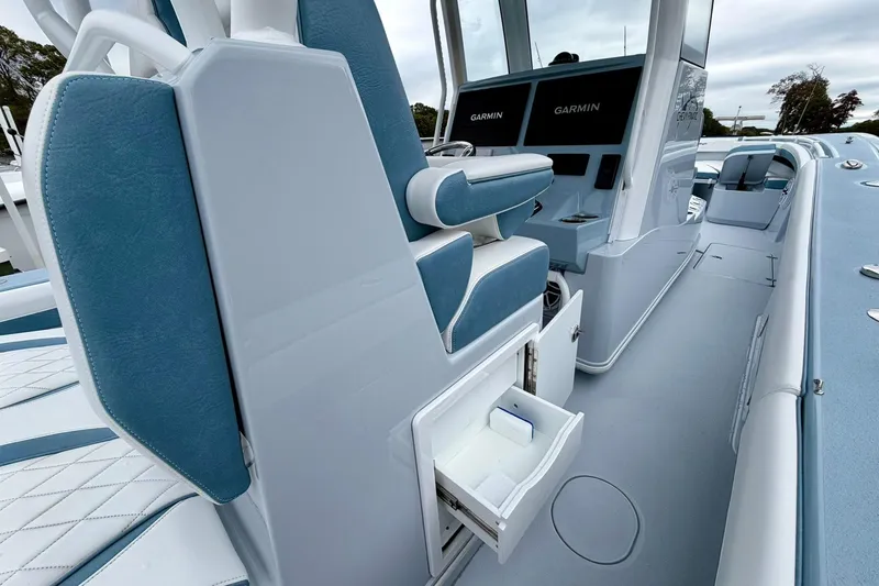 Slide: The Image of 2025 Yellowfin 36 Offshore boat interior with Garmin displays and storage compartments. - 26