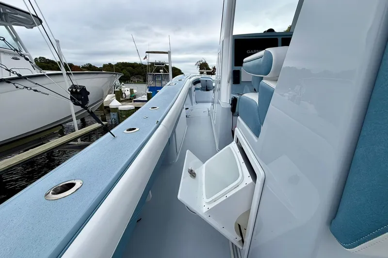 Slide: The Image of 2025 Yellowfin 36 Offshore boat interior with seating and storage, docked at marina. - 27