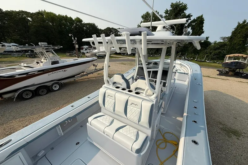 Slide: The Image of 2025 Yellowfin 36 Offshore boat with sleek design, parked outdoors. - 29