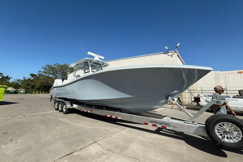 Slide: The Image of 2025 Yellowfin 36 Offshore boat on trailer under clear blue sky. - 32