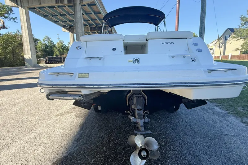 Slide: The Image of Rear view of a 2006 Sea Ray 270 SLX boat showing propeller and trailer. - 11