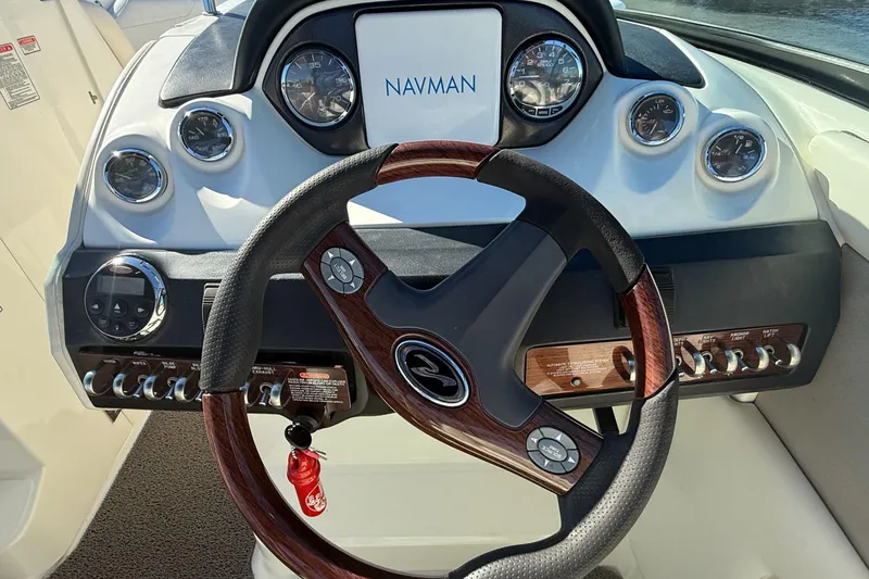 Slide: The Image of 2006 Sea Ray 270 SLX boat, rear view under a bridge, showcasing propeller and stern. - 14