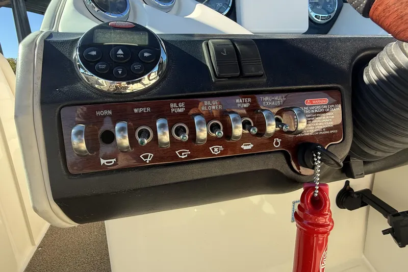 Slide: The Image of Interior of a 2006 Sea Ray 270 SLX boat with plush seating and steering wheel. - 15