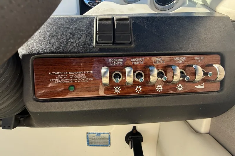 Slide: The Image of Interior of a 2006 Sea Ray 270 SLX boat with white seating and modern dashboard. - 16