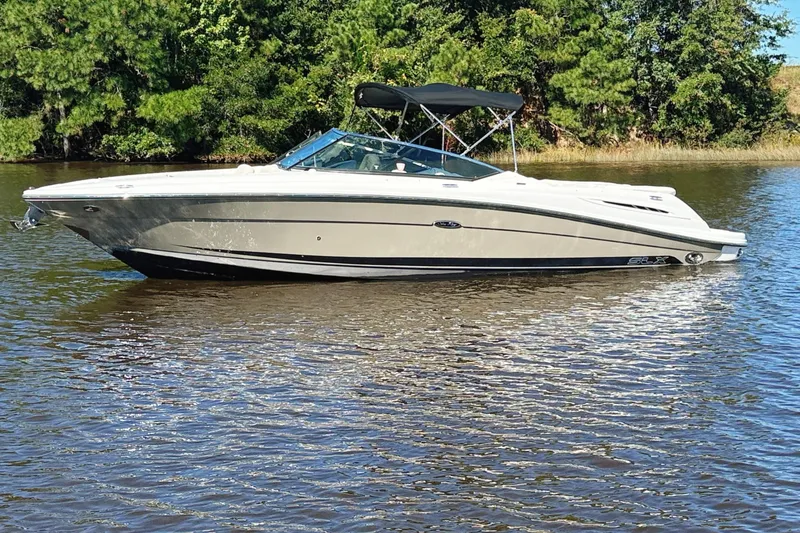 Slide: The Image of 2006 Sea Ray 270 SLX boat on trailer under bridge, ready for transport. - 2