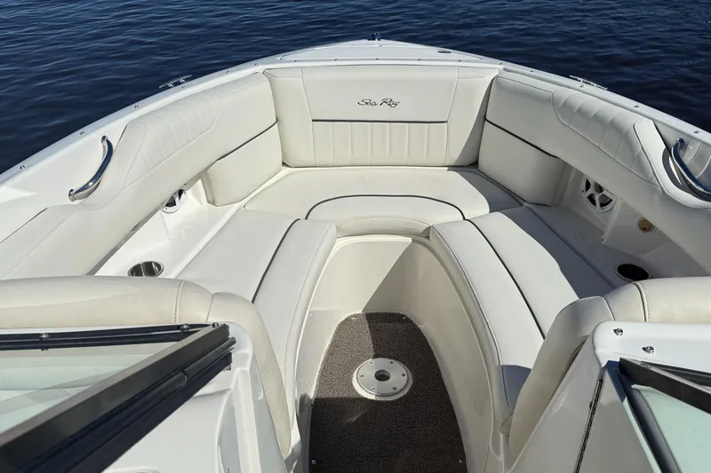 Slide: The Image of Interior of a 2006 Sea Ray 270 SLX boat with white seating and steering wheel. - 26