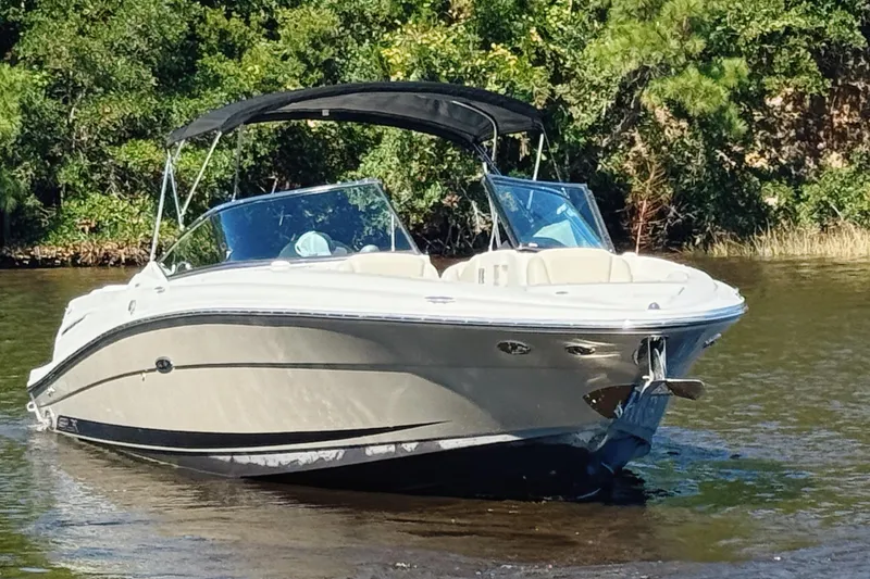 Slide: The Image of 2006 Sea Ray 270 SLX boat on calm water with lush green trees in the background. - 4