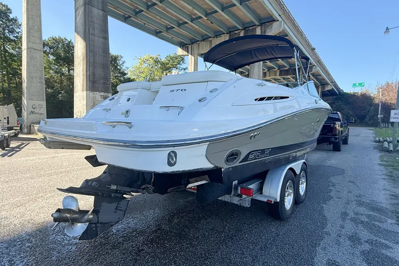 Slide: The Image of Luxurious 2006 Sea Ray 270 SLX boat interior with white seating and blue water backdrop. - 7
