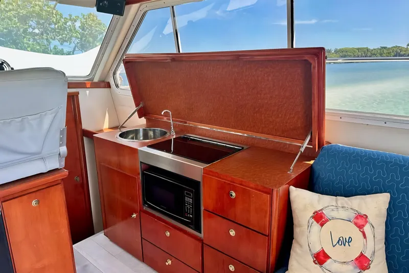 Slide: The Image of Interior of 2001 Zeta 32 Power Cat with kitchenette and scenic window view. - 10