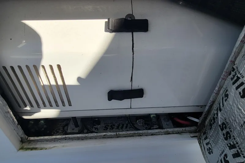 Slide: The Image of Cracked panel on 2001 Zeta 32 Power Cat boat, showing battery compartment. - 12