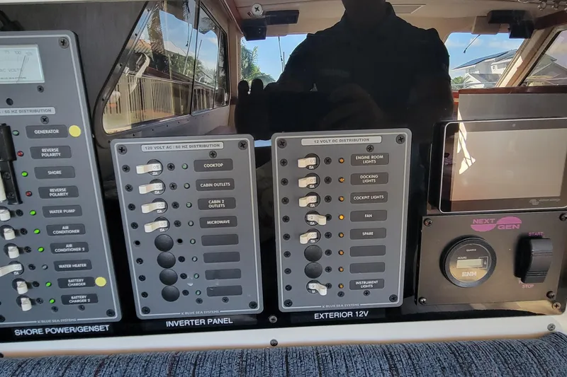 Slide: The Image of Control panel of a 2001 Zeta 32 Power Cat boat, featuring various switches and gauges. - 16
