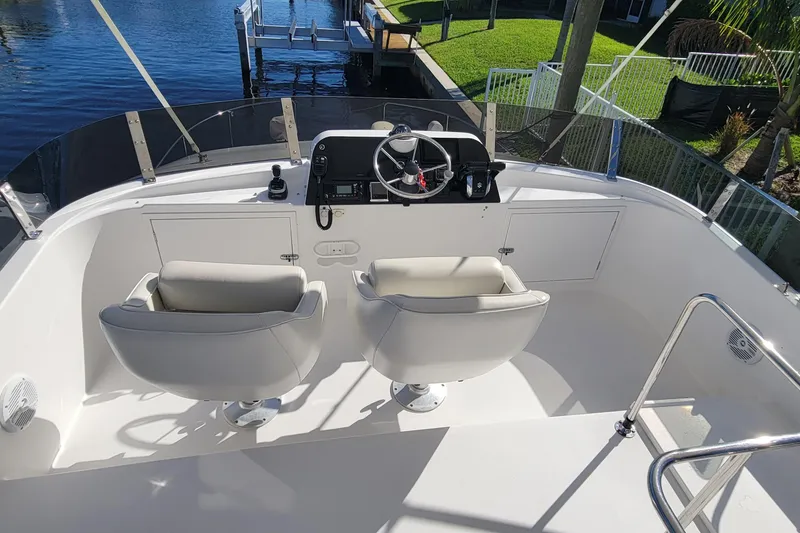 Slide: The Image of 2001 Zeta 32 Power Cat boat helm with dual seats and steering wheel. - 21