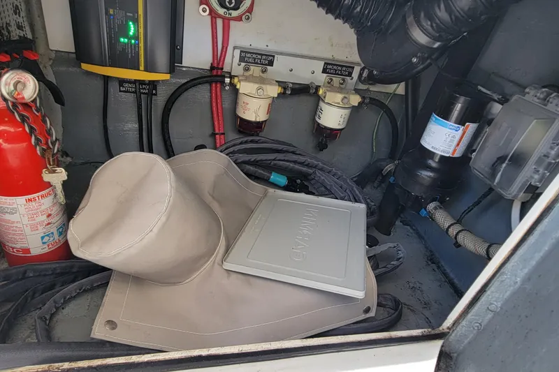 Slide: The Image of Engine compartment of a 2001 Zeta 32 Power Cat with fire extinguisher and fuel filters. - 25