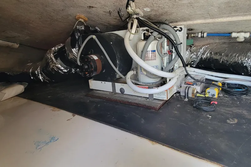 Slide: The Image of Engine compartment of a 2001 Zeta 32 Power Cat with visible machinery and wiring. - 37