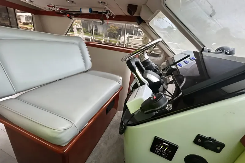 Slide: The Image of Interior of 2001 Zeta 32 Power Cat with steering wheel and seating area. - 4