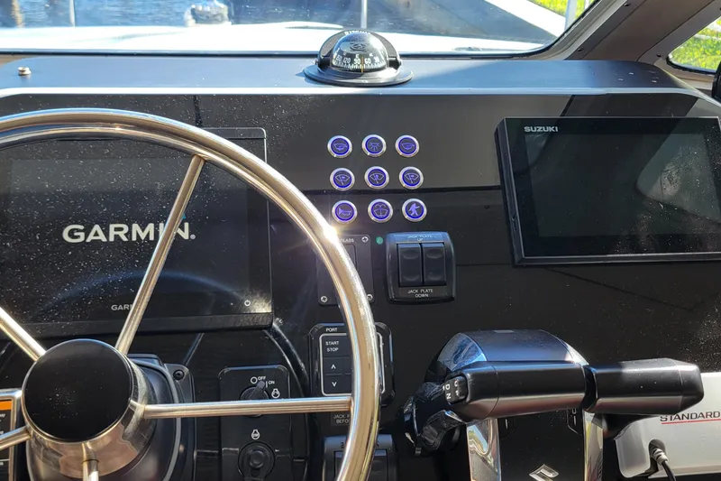 Slide: The Image of Control panel of a 2001 Zeta 32 Power Cat with Garmin and Suzuki displays. - 43