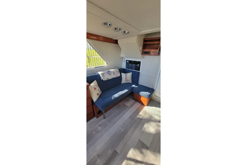 Slide: The Image of Interior of 2001 Zeta 32 Power Cat with blue seating and wooden accents. - 45