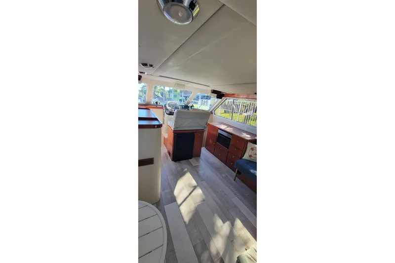 Slide: The Image of Interior of 2001 Zeta 32 Power Cat boat with modern furnishings and wood flooring. - 48