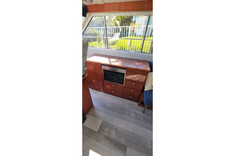 Slide: The Image of Interior of 2001 Zeta 32 Power Cat with wooden cabinetry and microwave. - 49