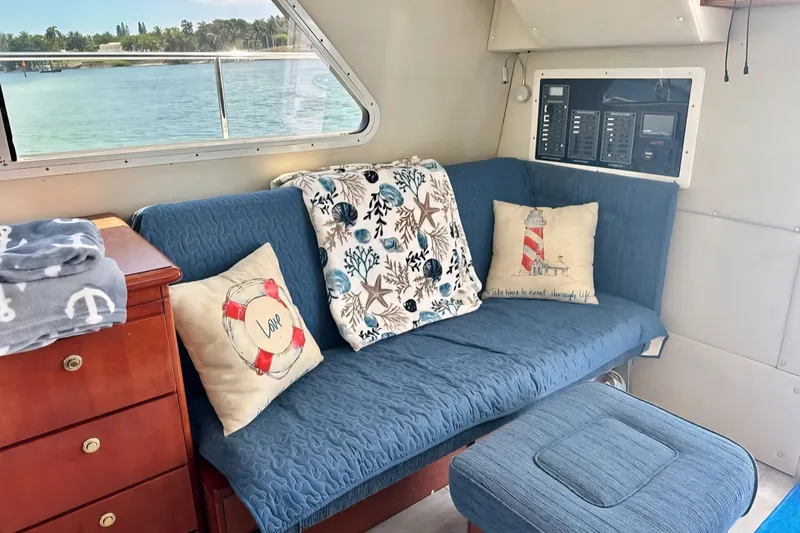 Slide: The Image of Interior of 2001 Zeta 32 Power Cat with blue seating and nautical-themed decor. - 5