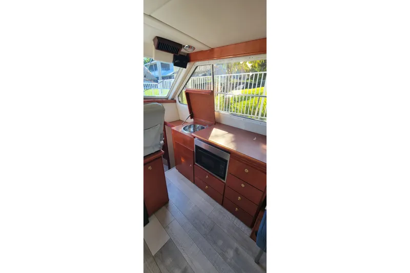 Slide: The Image of Interior of 2001 Zeta 32 Power Cat with kitchenette, featuring sink and microwave. - 50