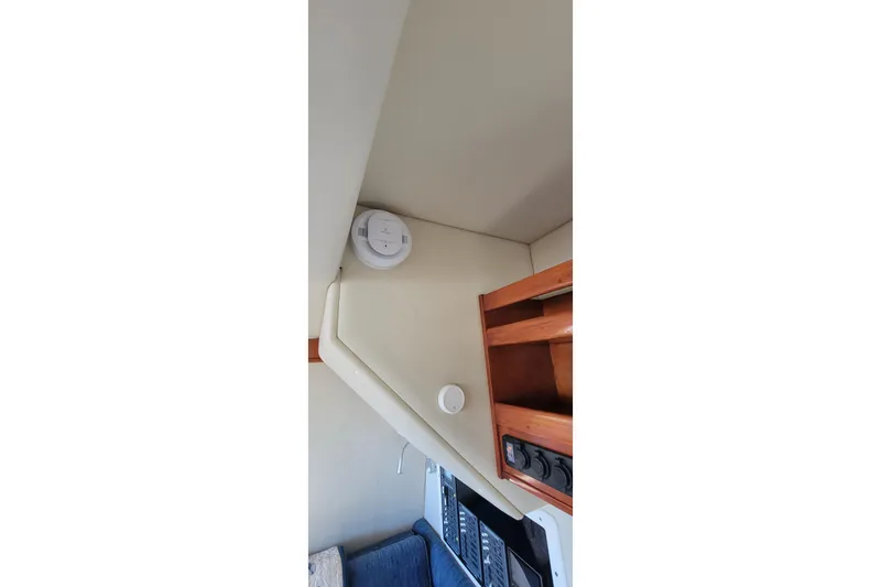 Slide: The Image of Interior of 2001 Zeta 32 Power Cat with smoke detector and wooden shelving. - 53