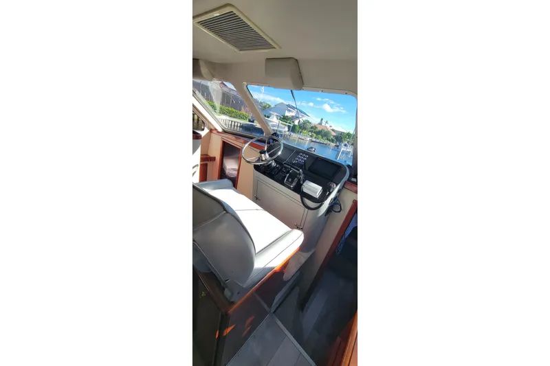 Slide: The Image of Interior view of 2001 Zeta 32 Power Cat boat cockpit with steering wheel and controls. - 55