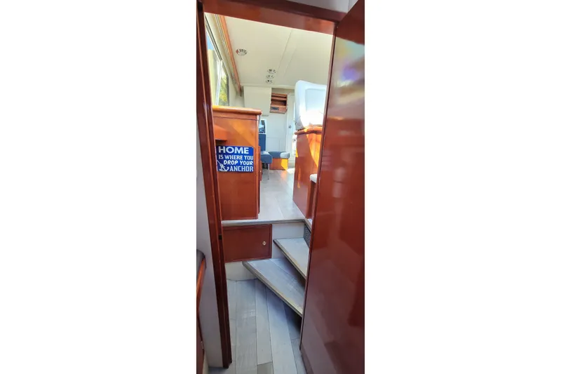 Slide: The Image of Interior view of 2001 Zeta 32 Power Cat with wooden stairs and nautical decor. - 56