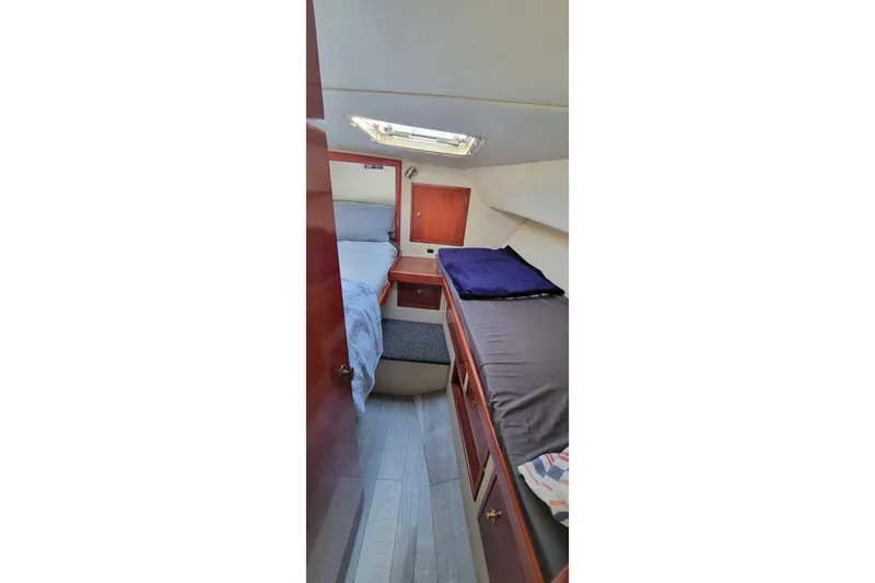 Slide: The Image of 2001 Zeta 32 Power Cat cabin interior with twin beds and wooden cabinetry. - 57
