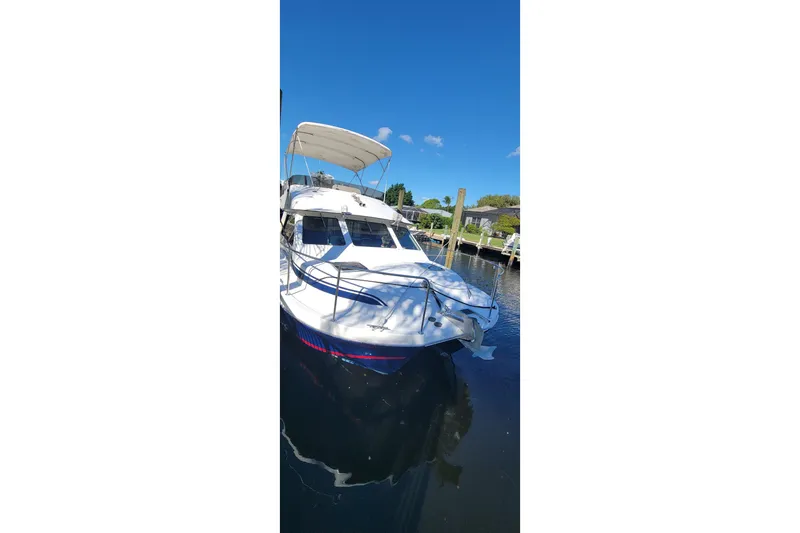 Slide: The Image of 2001 Zeta 32 Power Cat boat docked on a sunny day. - 6