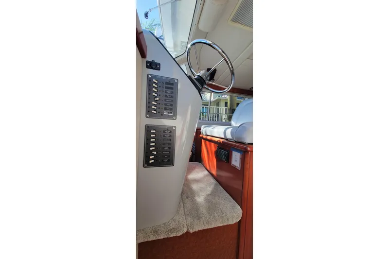 Slide: The Image of Interior view of 2001 Zeta 32 Power Cat boat showing steering wheel and control panel. - 60