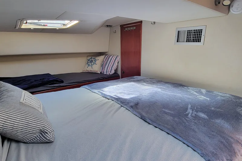 Slide: The Image of Cozy cabin interior of 2001 Zeta 32 Power Cat with comfortable bedding and nautical decor. - 61