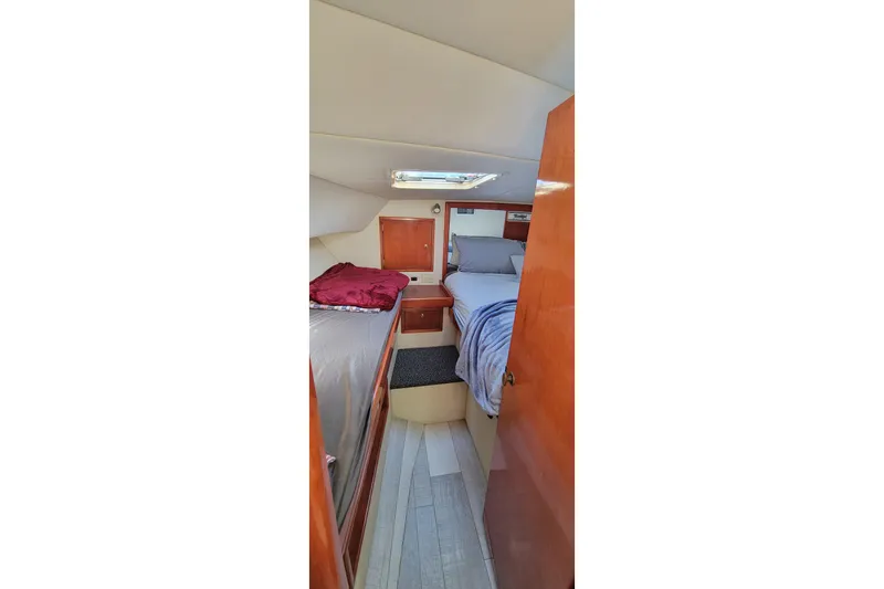 Slide: The Image of Interior cabin of 2001 Zeta 32 Power Cat with cozy beds and wooden finish. - 62