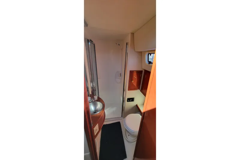 Slide: The Image of 2001 Zeta 32 Power Cat bathroom with sink, toilet, and shower. - 63