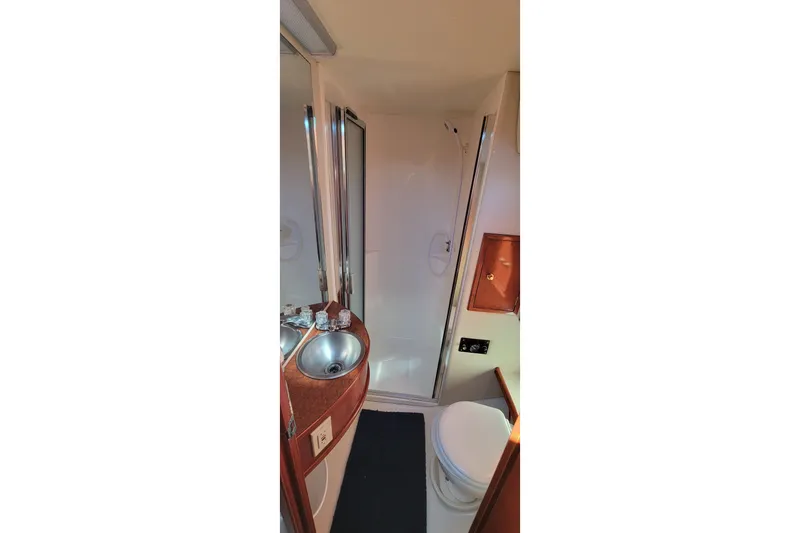 Slide: The Image of Bathroom interior of 2001 Zeta 32 Power Cat with sink, toilet, and shower. - 64