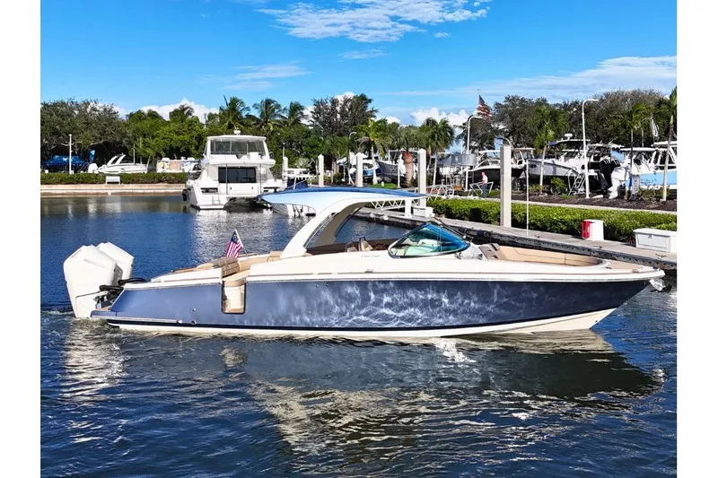 The Image of 2026 Chris-Craft Launch 35 GT boat docked in a marina under a clear blue sky. - 0