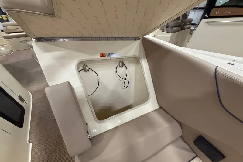 Slide: The Image of 2026 Chris-Craft Launch 35 GT interior storage compartment with beige seating and upholstery. - 19