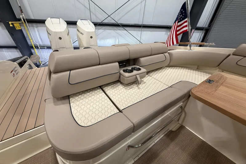 Slide: The Image of 2026 Chris-Craft Launch 35 GT interior with beige seating and American flag. - 8