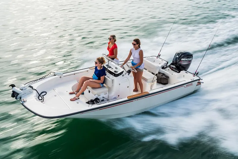 Slide: The Image of 2026 Boston Whaler 170 Montauk boat on trailer in parking lot. - 1